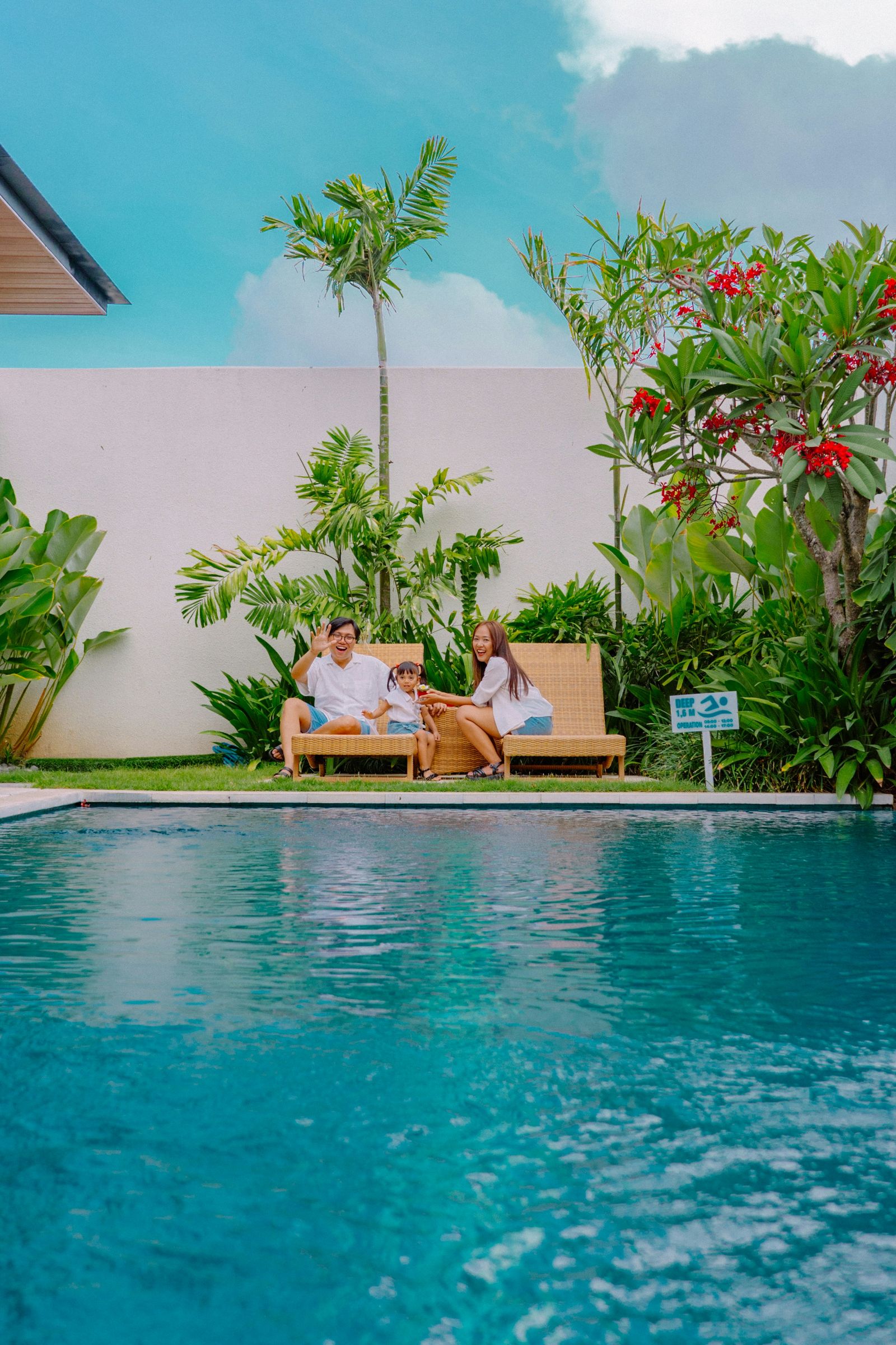 Family relaxing beside a private pool at a tropical Bali villa