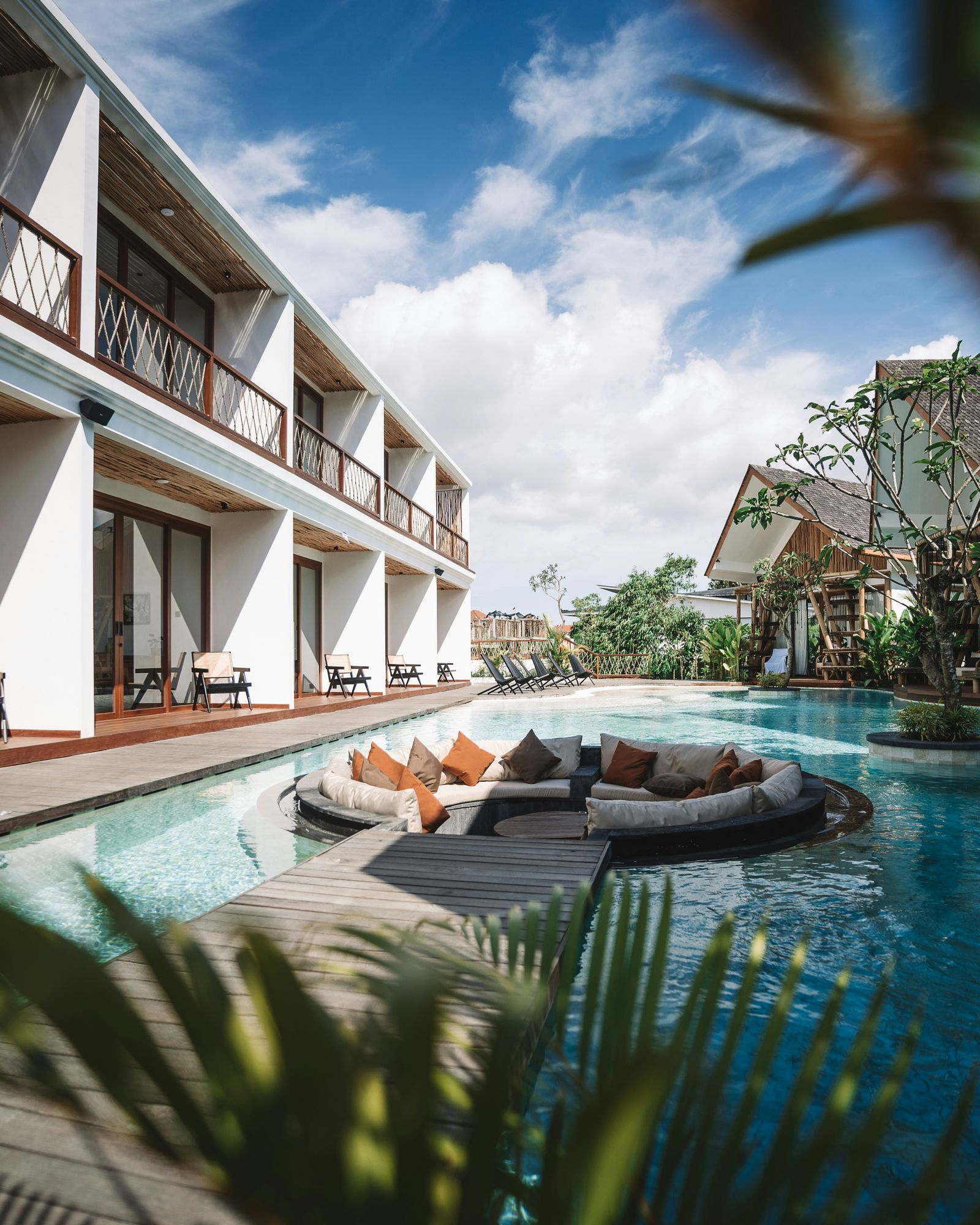 Hotel pool with lounge chairs in a tropical setting