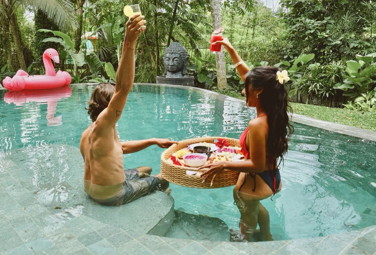 Hubuddha three bedroom villa pool with guests and tropical greenery
