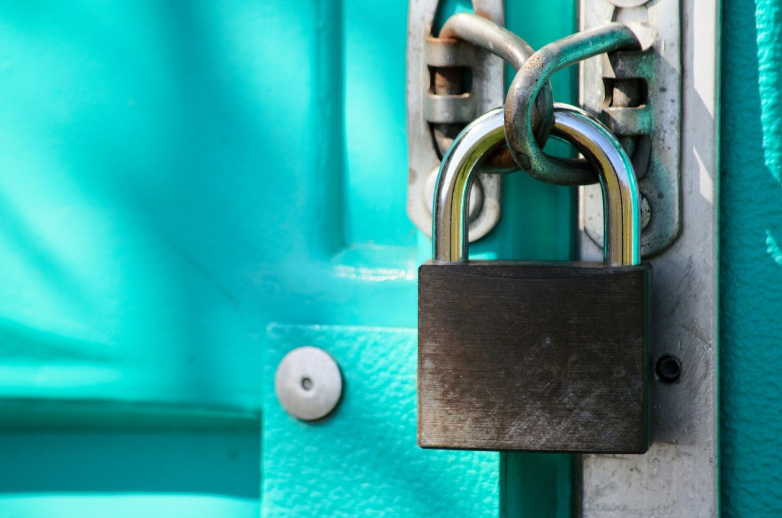 Close-up of a padlock and chain used for property security