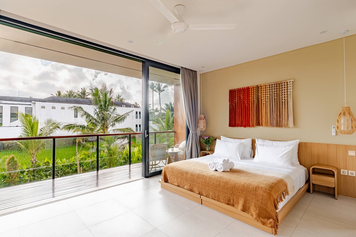 Master bedroom with rice field and palm tree view at Hubuddha Two Bedroom Villa Ubud Bali