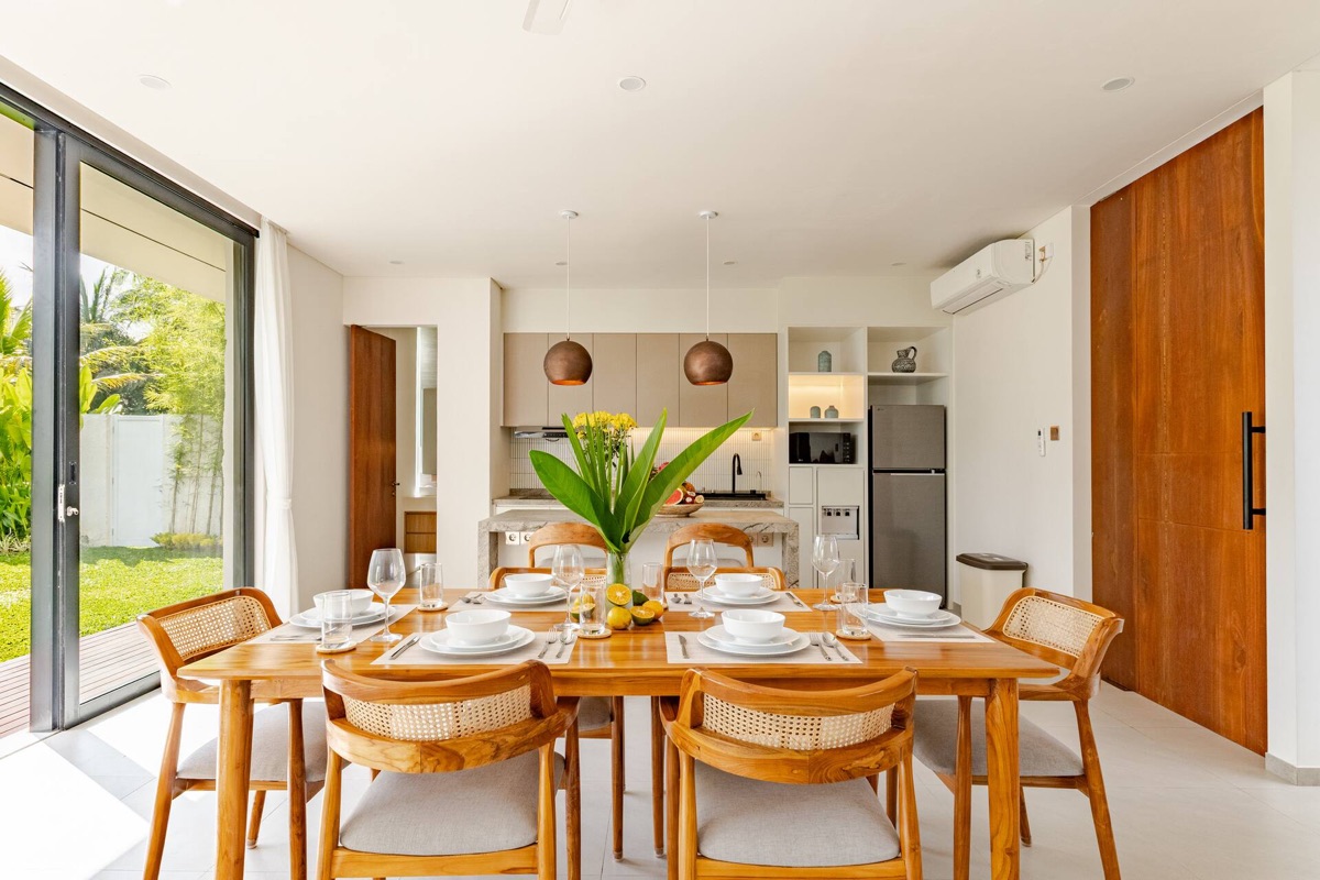 Open dining table and kitchen with garden view at Hubuddha Two Bedroom Villa Ubud Bali