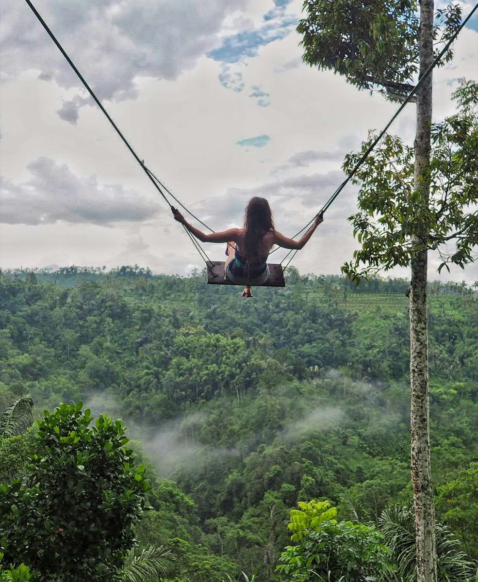 Girl on the famous Bali swing over the jungle valley, Ubud